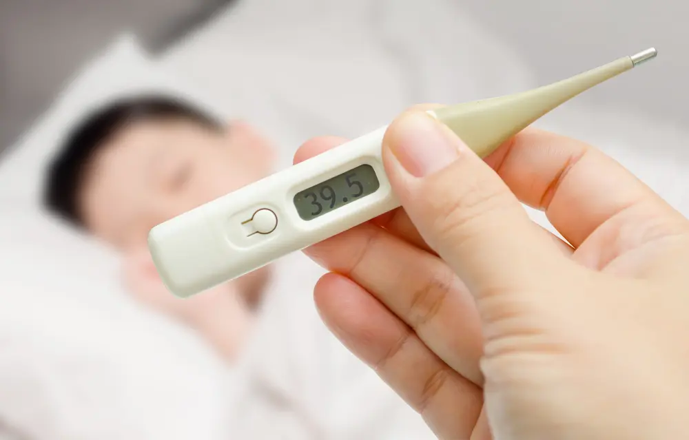 Pessoa verificando a temperatura, representando o cuidado com a saúde durante o uso de medicação injetável